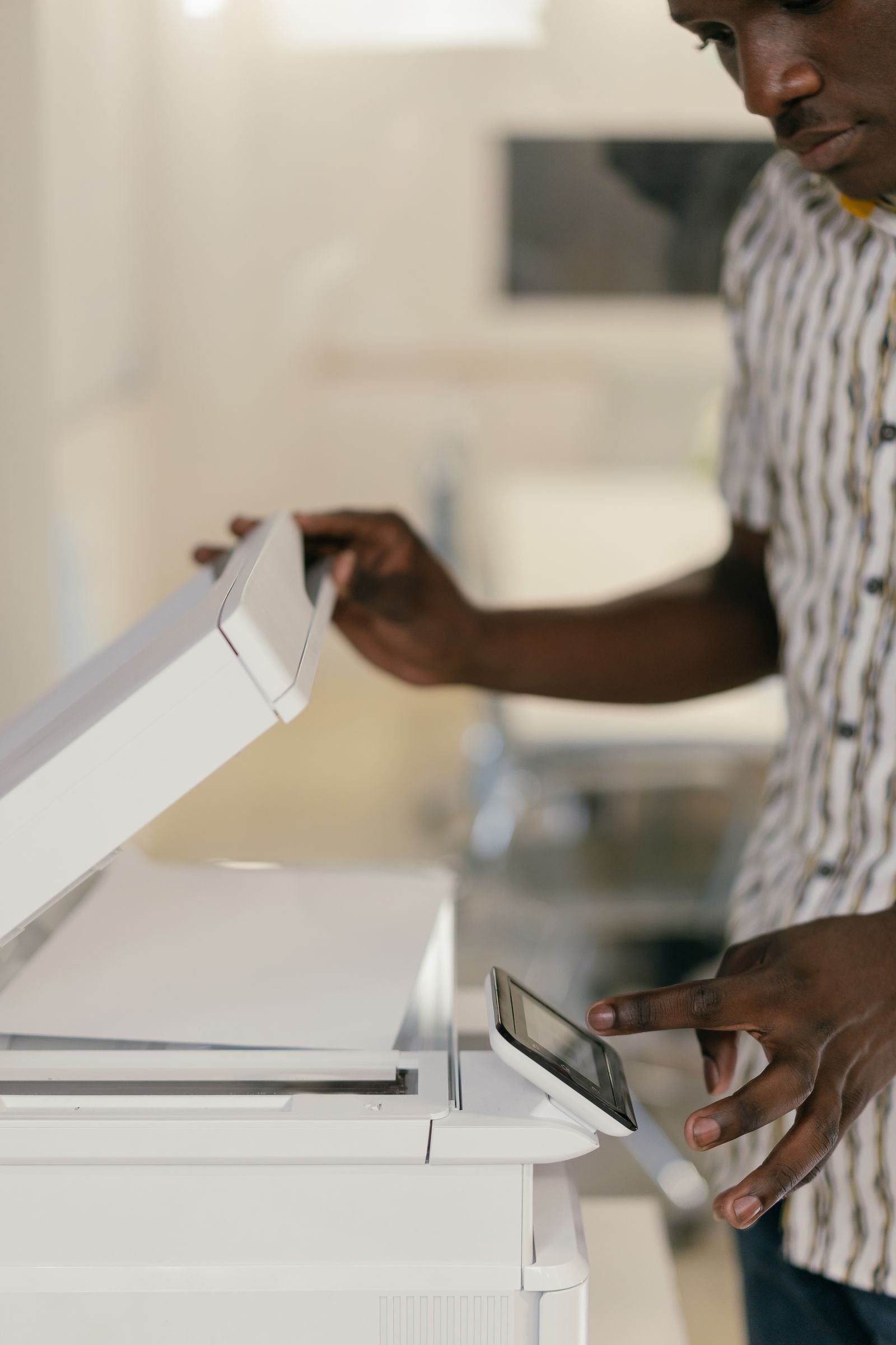 Man operating a photocopier - office copier drum and cartridge maintenance Content-Disposition: form-data; name="caption" Man operating a photocopier - office copier drum and cartridge maintenance